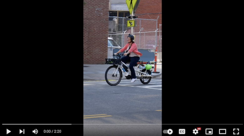 Councilmember Nadeau rides her cargo bike along Columbia Road.